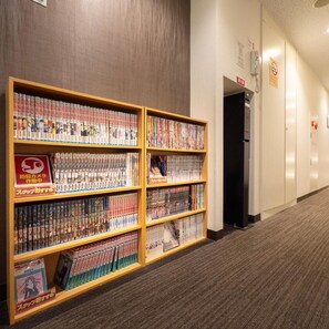 Een gang met een boekenplank vol met dvd's en manga.