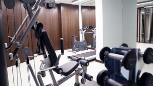 A gym with various exercise equipment, including a bench press, dumbbells, and cardio machines. - Galata's Hotel Istanbul (Istanbul)