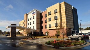 A modern hotel with a flat roof, a central entrance, and a parking lot. - Fairfield Inn Suites Dunn I 95 (Dunn)