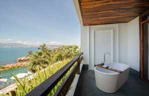 A balcony with a view of a city skyline and a pool. - Alibu Resort (Nha Trang)