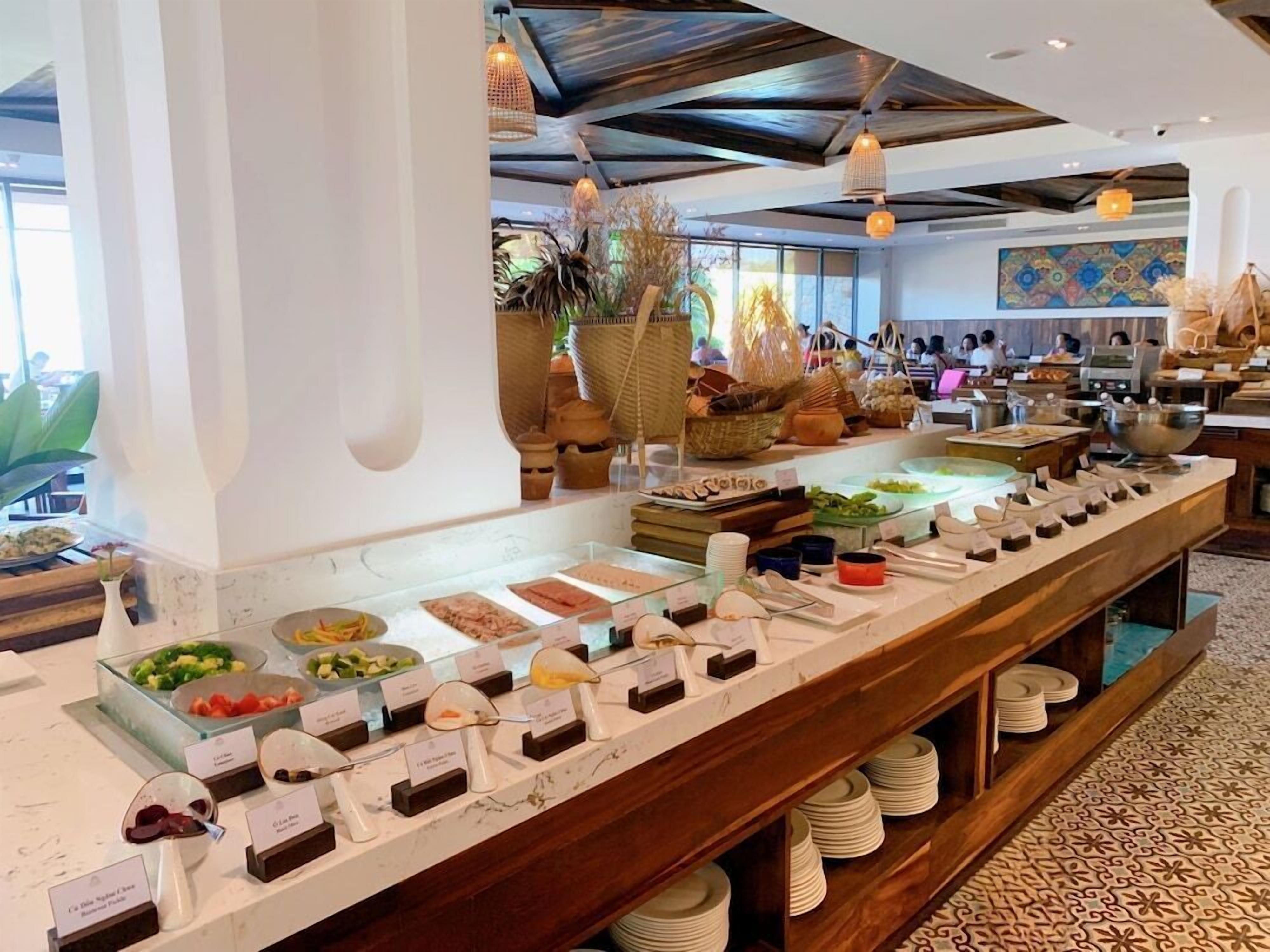 A buffet setup with various food items and utensils.