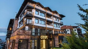 A multi-story hotel with balconies and a sign that reads "ores". - Ores Boutique Hotel (Bansko)