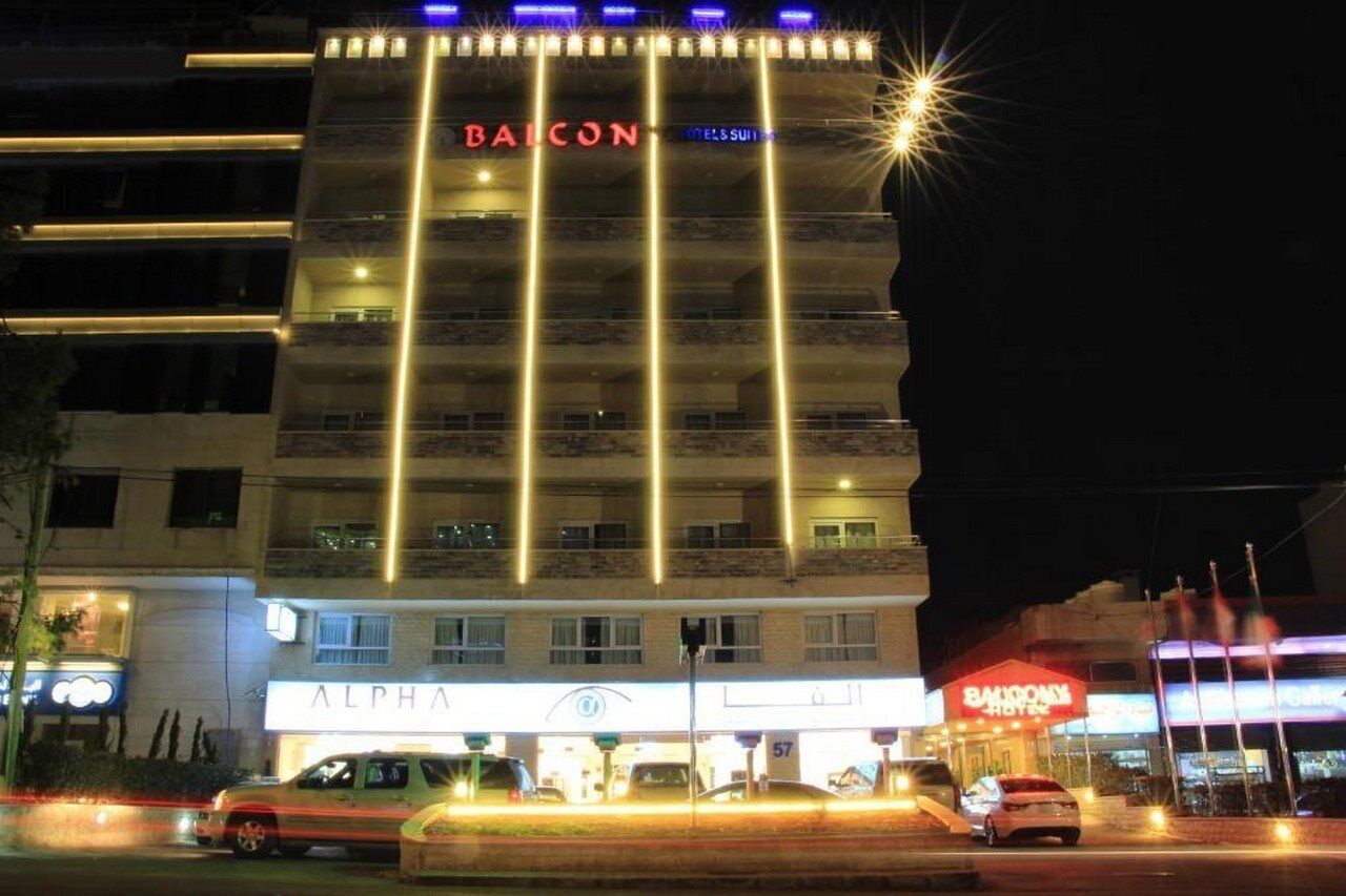 A multi-story hotel with balconies, a prominent 'BALCONY' sign, and a 'BARRACUDA' restaurant.