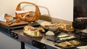 A variety of breads and cheeses displayed on a counter. - Aurora Resort by One Hotels (Tsaghkadzor)