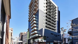 A modern multi-story building with a unique facade, featuring balconies and large windows. - Daiwa Royal Hotel D City Nagoya Fushimi (Nagoya)