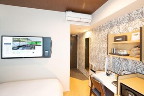 A hotel room with a bed, a TV mounted on the wall, a hair dryer, and a shelf with toiletries. - Daiwa Royal Hotel D City Nagoya Fushimi (Nagoya)