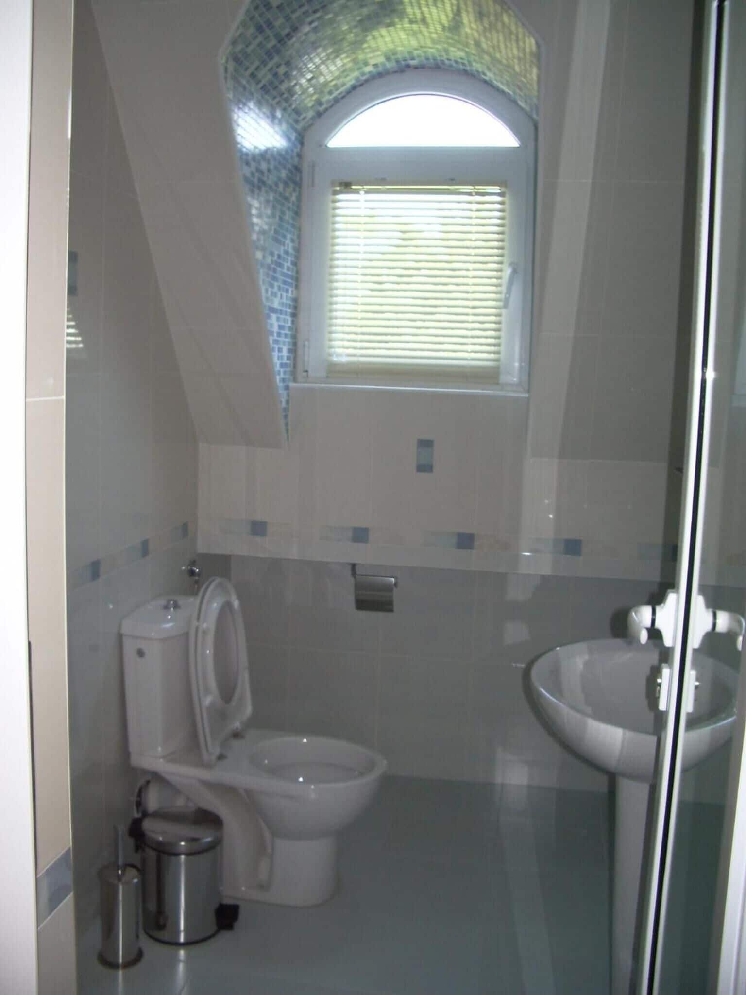 A bathroom with a toilet, bidet, and sink.