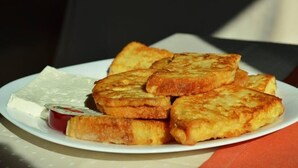 A plate of French toast with a side of butter and jam. - Hotel Avis (Sandanski)