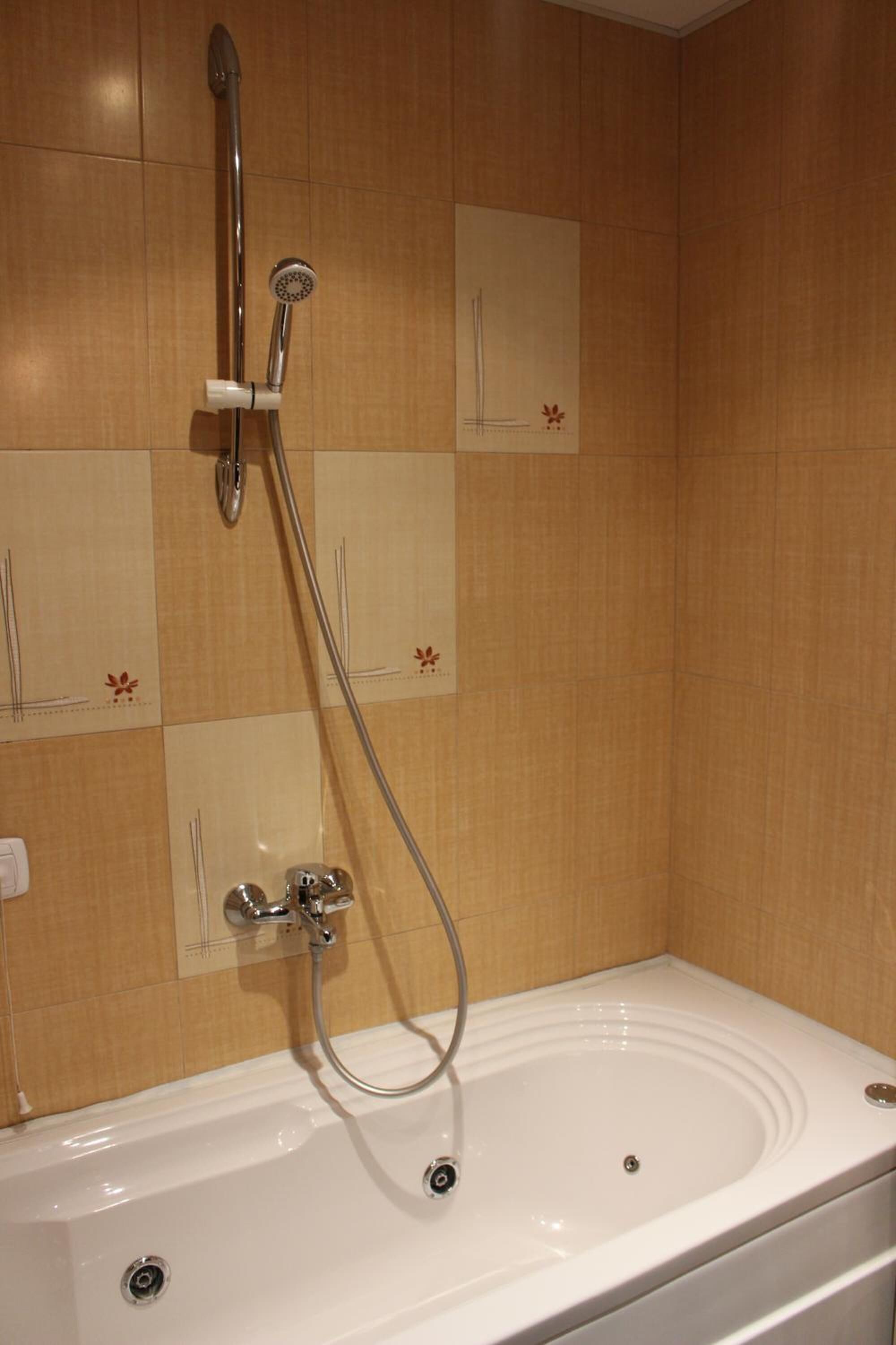 A bathroom with a bathtub, a shower, and a toilet.