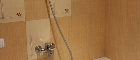 A bathroom with a bathtub, a shower, and a toilet.