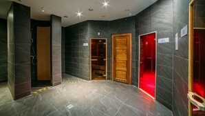 A modern bathroom with dark tiles, a shower area, and a red-lit vanity. - Hotel Mikolajki Resort By Desilva (Mikolajki)