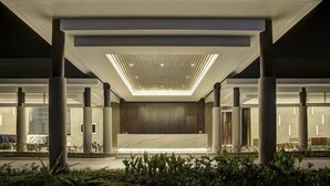 A modern building with a central open space, columns, and a ceiling with recessed lighting. - Mambruk Anyer (Anyer)