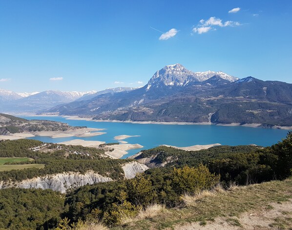 Un paisaje montañoso con un lago y un pico destacado.