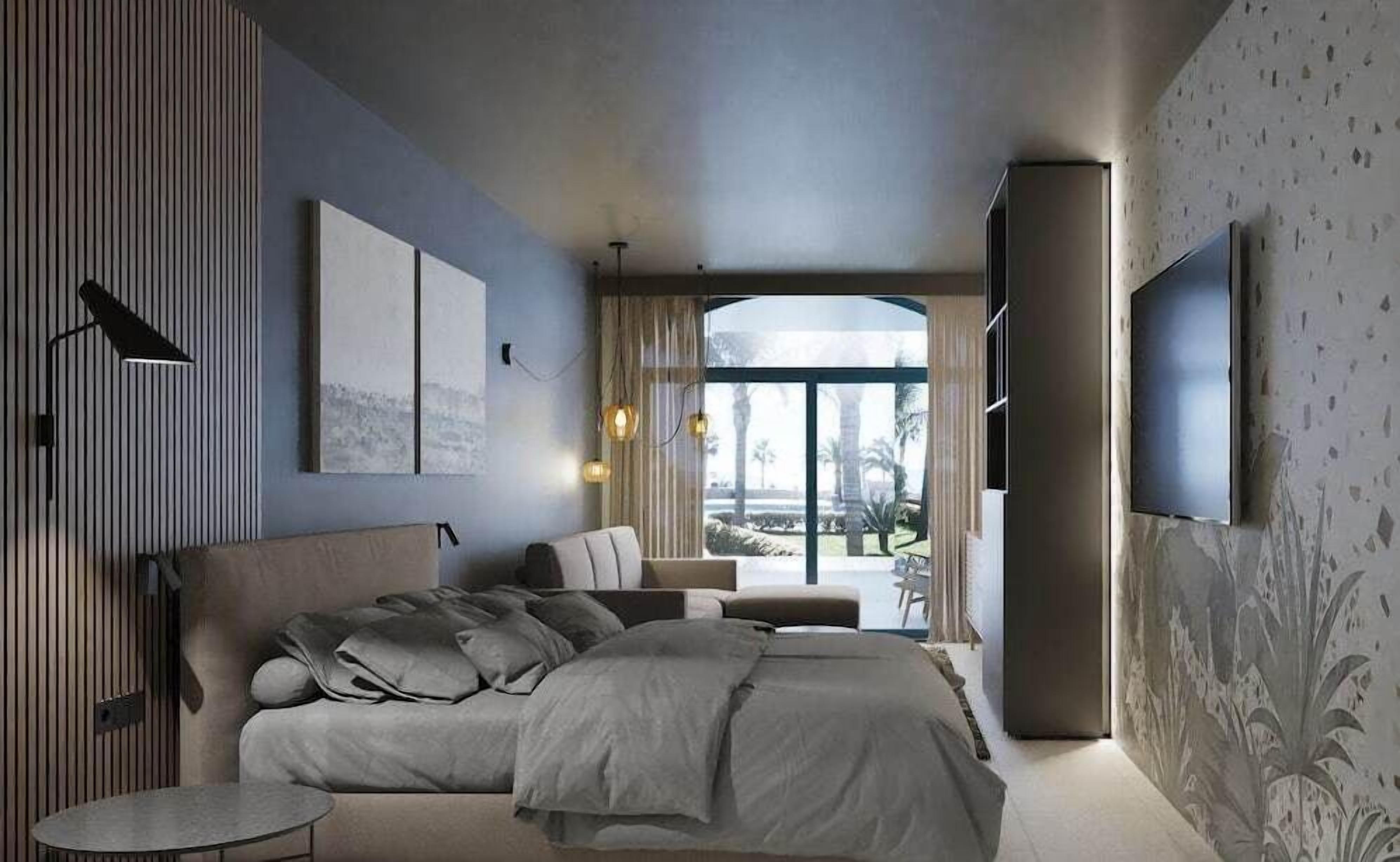 A modern bedroom with a large bed, a TV, and a view of the outdoors.