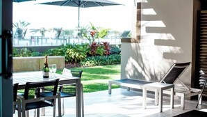 An outdoor patio with a table, chairs, and umbrellas. - Seahaven Resort (Sunshine Coast)