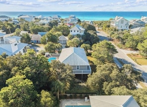 A residential area with houses surrounded by trees and a view of the ocean. - The Blue Parrot Cottage: ONE BLOCK TO BEACH ACCESS, PRIVATE POOL, SLEEPS 6! (Santa Rosa Beach)