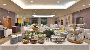 A buffet setup with various food items and serving utensils. - San Marco (Noceto)