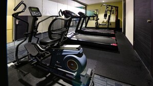 A gym with treadmills, an elliptical, and a rowing machine. - Hotel Imperial (Kuala Lumpur)