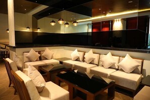 A modern lounge area with sofas, tables, and pendant lighting. - Hyatt Regency Amritsar Hotel & Spa (Amritsar)