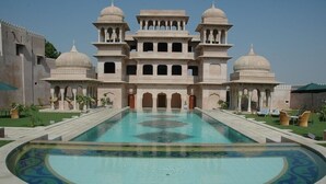 A large building with a central pool, multiple domes, and a symmetrical design.