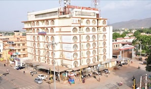 A multi-story building with arched windows and signage for 'SHANBHAG INTERNATIONAL'. - Shanbhag Towers International (Hospet)