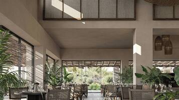 Un espacio interior amplio con techos altos, ventanas grandes y varios conjuntos de asientos.