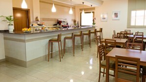A hotel dining area with a buffet counter, multiple seating arrangements, and a clean, tiled floor. - Complejo Hostelero Torrijos (Cheste)
