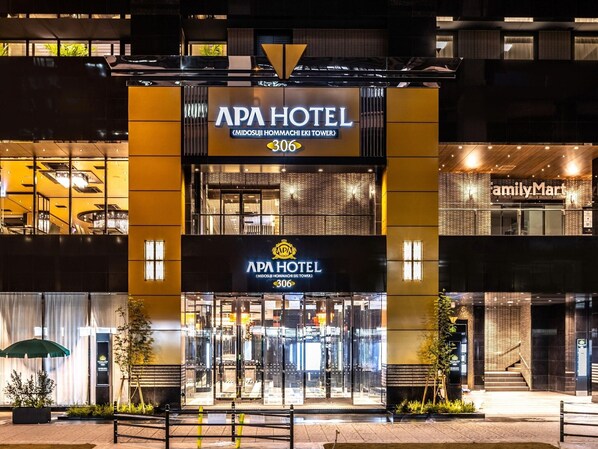 The APA Hotel with a modern facade, a prominent entrance, and a visible FamilyMart store. - APA Hotel Resort Midosuji Hommachi Eki Tower (Osaka)