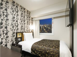 A hotel room with a bed, a bedside table, a television, and a window with a cityscape view. - APA Hotel Resort Midosuji Hommachi Eki Tower (Osaka)