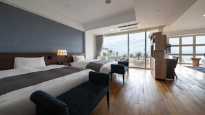 A modern hotel room with two beds, a sofa, a balcony with a view, and a dining area. - Sunshine Sazan Seto (Suooshima)
