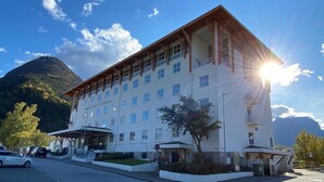 A multi-story hotel with a flat roof and a covered entrance area.