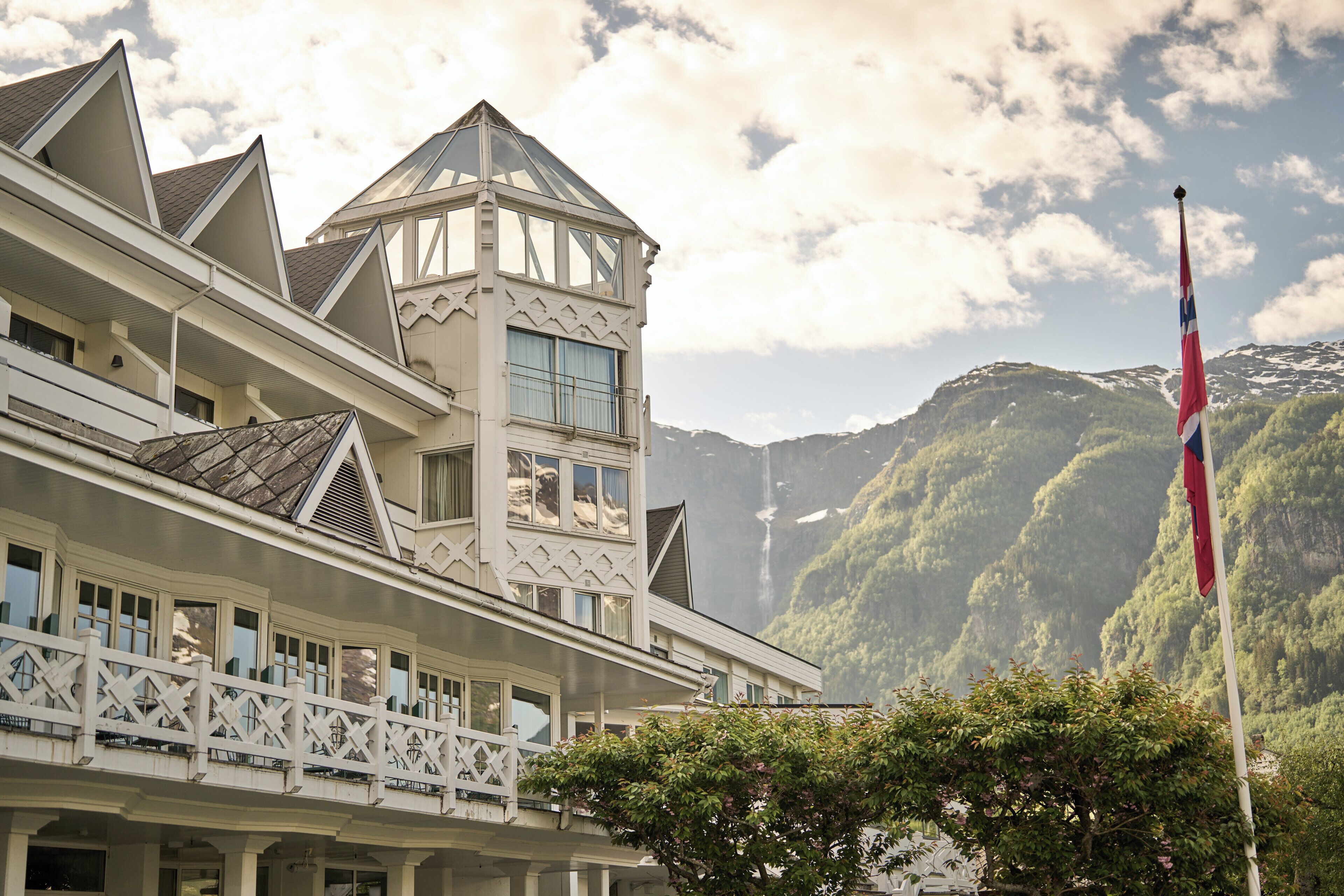 A hotel with a distinctive architectural style, featuring a prominent tower and multiple balconies.