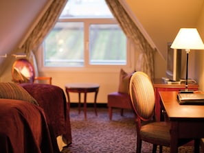 A hotel room with two beds, a small table, a chair, a lamp, and a television. - Ullensvang (Ullensvang)