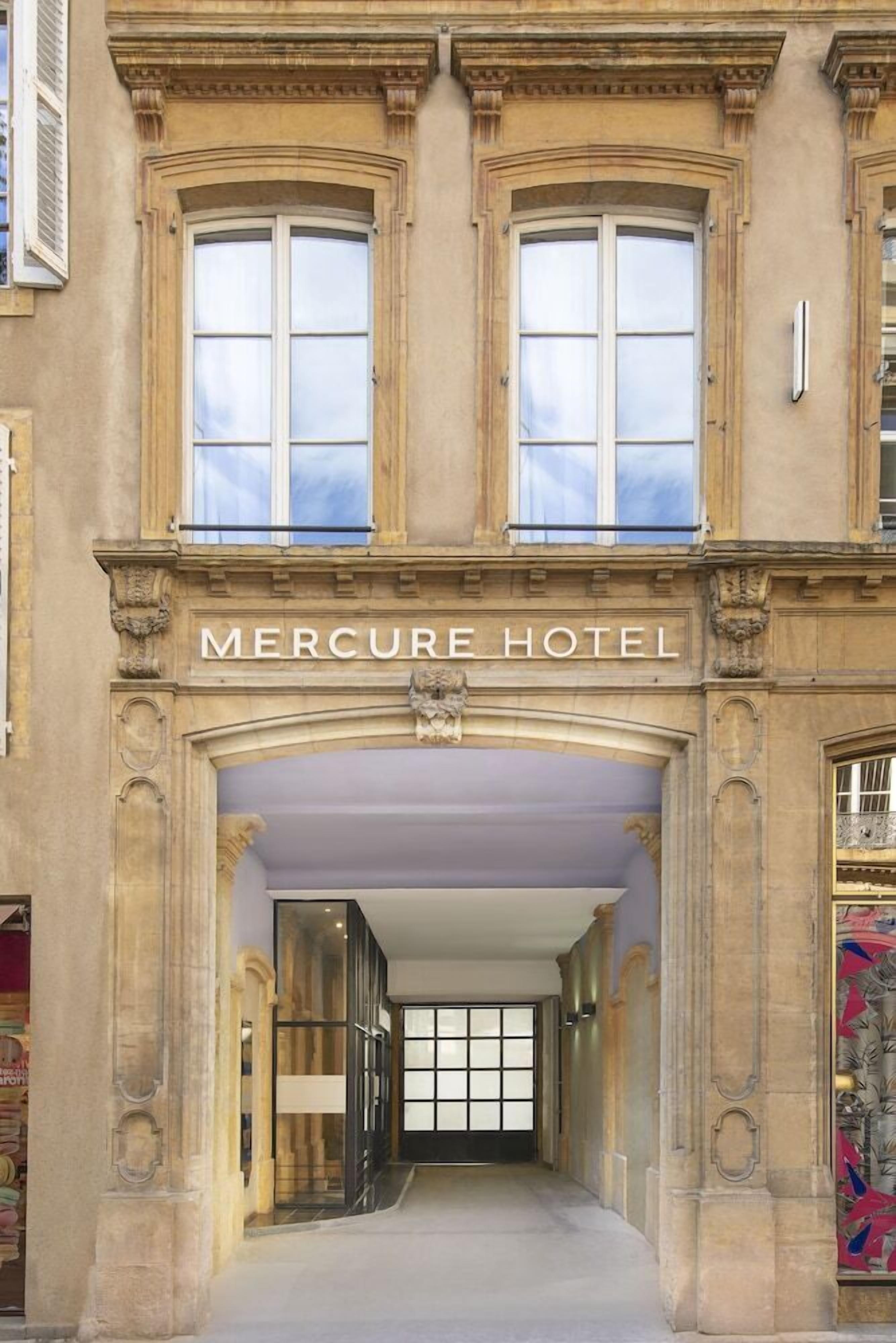L’extérieur de l’hôtel Mercure se distingue par son imposante entrée, ses grandes fenêtres et ses éléments architecturaux classiques.