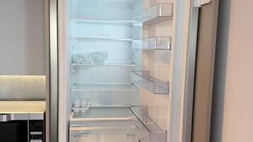 A refrigerator with multiple shelves and a built-in ice maker.