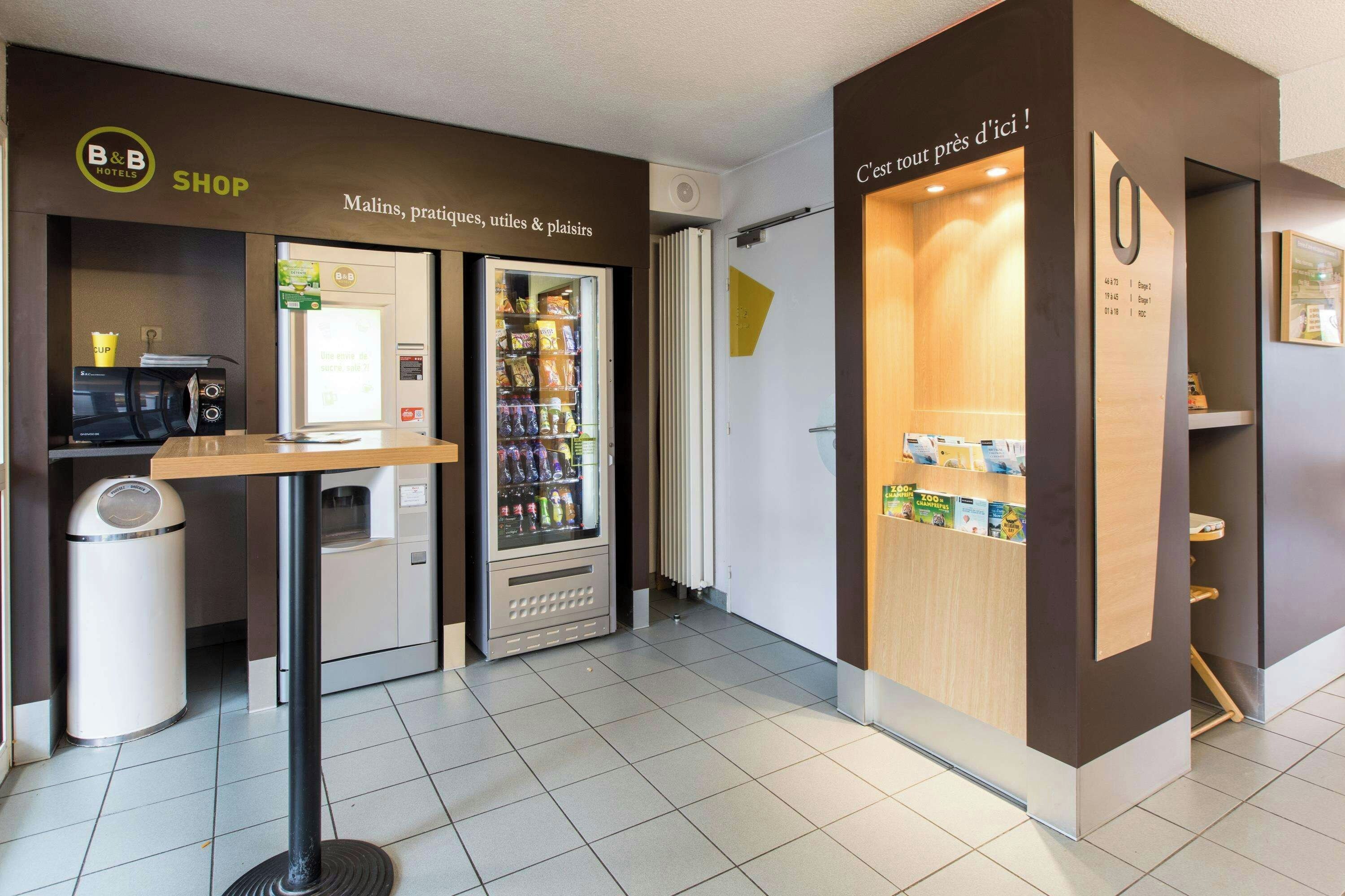A B&B hotel shop with a vending machine, a coffee machine, and a self-service beverage dispenser.