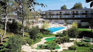 A hotel with a swimming pool, a tennis court, and a landscaped garden. - Club Belambra Le Normont (Dourdan)