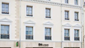 A building with a classic architectural style, featuring symmetrical windows and decorative moldings. The facade includes a sign for 'ibis Styles' indicating a business establishment. - Ibis Styles Chlons-en-champagne Centre (Chalons-en-Champagne)