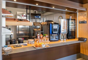 A breakfast bar with a coffee machine, toaster, and refrigerator. - B&B Hôtel Lyon Saint-bonnet Mi-plaine (Saint-Bonnet-de-Mure)