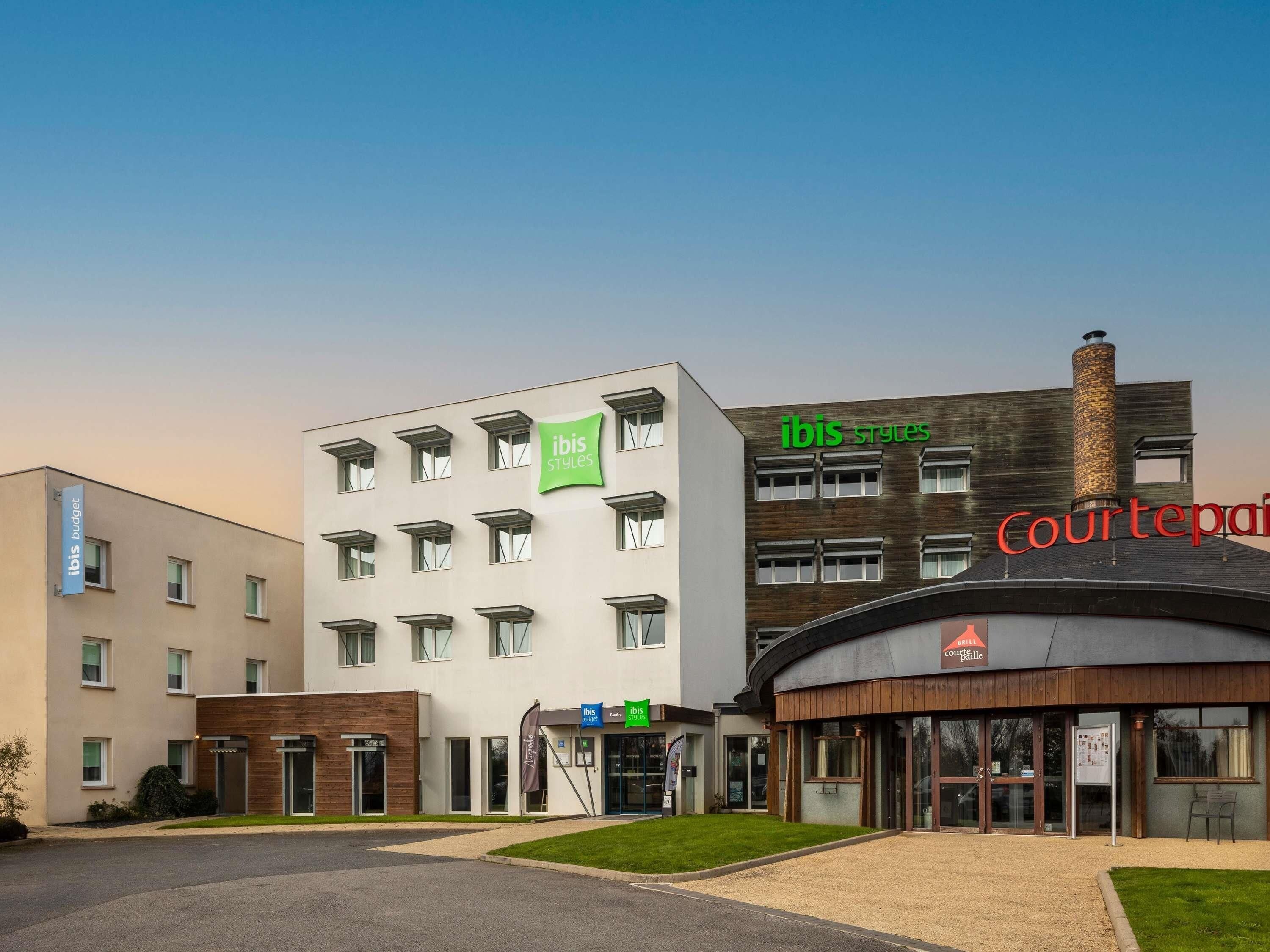 A modern hotel with multiple buildings, including a Courtyard by Marriott and an ibis hotel.