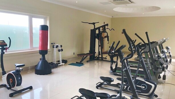 A gym with various exercise equipment including treadmills, stationary bikes, and weight machines. - Lan Rung Phuoc Hai Resort And Spa (Long Dat)