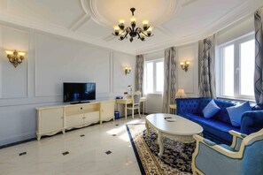 A living room with a television, sofa, coffee table, and decorative lighting. - Lan Rung Phuoc Hai Resort And Spa (Long Dat)