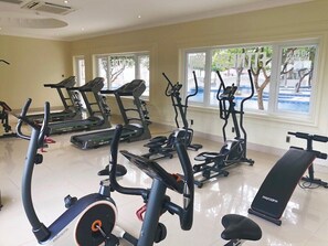 A gym with treadmills, elliptical machines, and a bench. - Lan Rung Phuoc Hai Resort And Spa (Long Dat)
