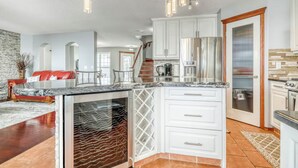 A modern kitchen with white cabinets, stainless steel appliances, and a marble countertop. - 2 Suites, 6 Beds +Sofa Bed | Sauna|Sleeps 14 (Calgary)