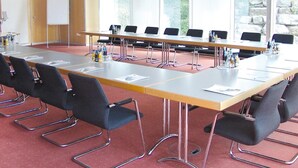 A conference room with a long table, chairs, a whiteboard, and large windows. - Seligweiler (Elchingen)