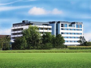 A modern hotel building with multiple floors, a flat roof, and a sign indicating it is a hotel. - Seligweiler (Elchingen)