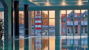 A pool area with clear views of buildings and a lighthouse. - Precise Resort Hafendorf Rheinsberg (Rheinsberg)