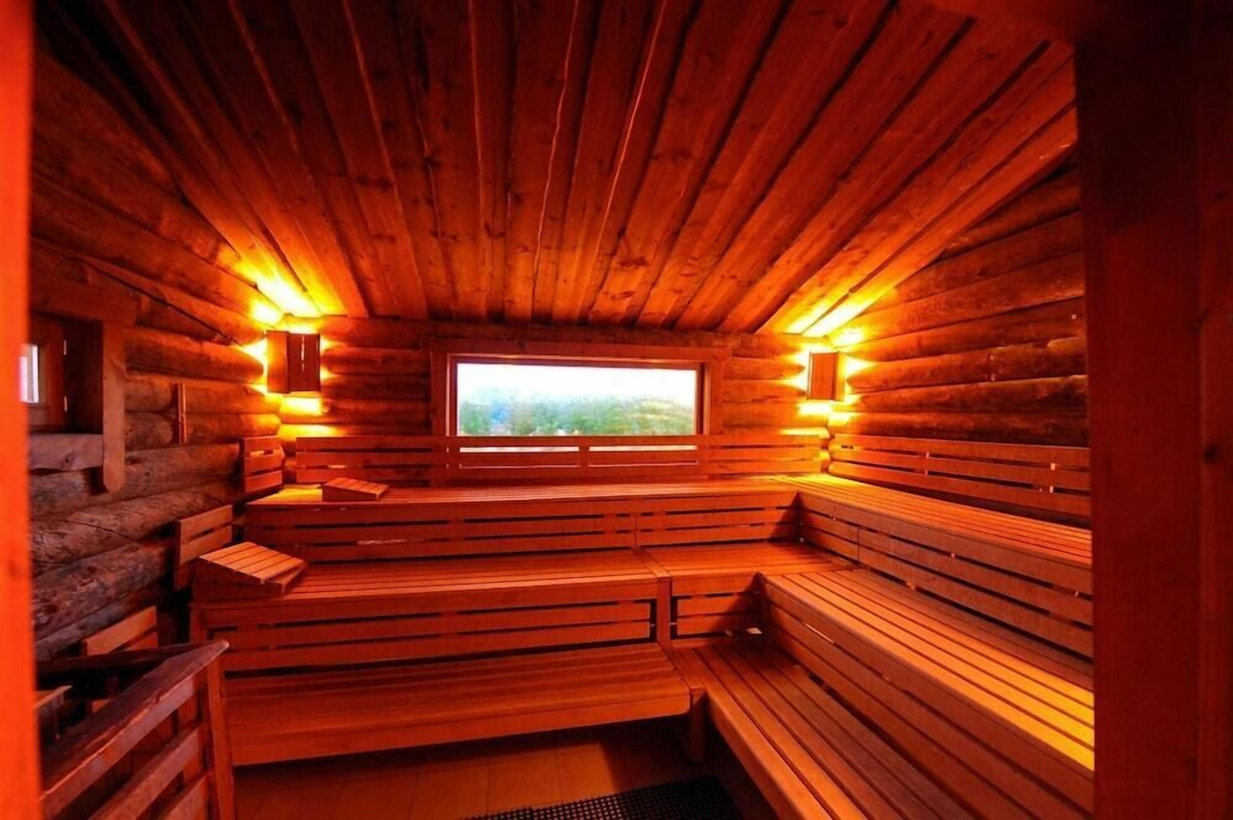 A sauna with wooden benches and a window.