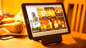A tablet displaying a hotel website with sections labeled "Willkommen," "Wellness/Fitness," "Konferenzen," and "Erlebnis." - Eisenacher Hof (Eisenach)