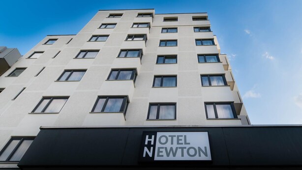 A multi-story hotel building with a sign reading 'HOTEL NEWTON.' - Hotel Newton Heilbronn (Heilbronn)